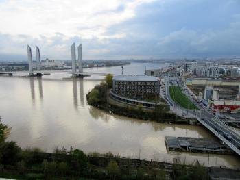 Pont Jacques Chaban Delmas, crossing the Garonne River, and the city of Bordeaux	as seen from the terrace outside La Cité du Vin's eighth-floor tasting room le belvédère — Bordeaux, France. 